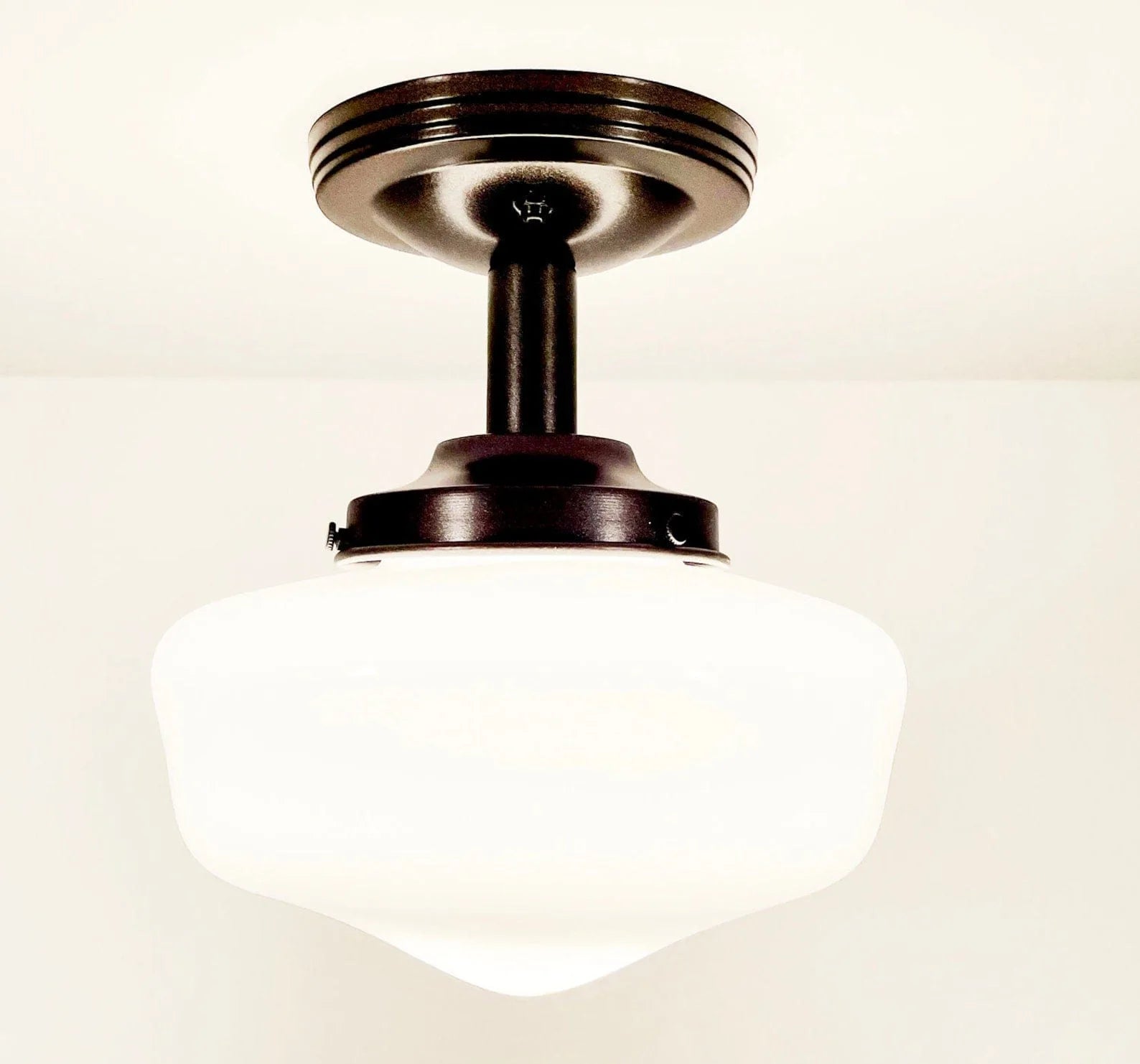 Antique milk glass ceiling fixture with dark bronze finish.
