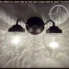 Antique glass double wall sconce; clear glass shades, bronze finish.
