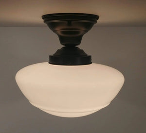 Milk glass ceiling fixture with dark bronze finish, installed on a light gray ceiling.
