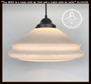 Cream milk glass pendant light with black metal fixture; double-layered shade.
