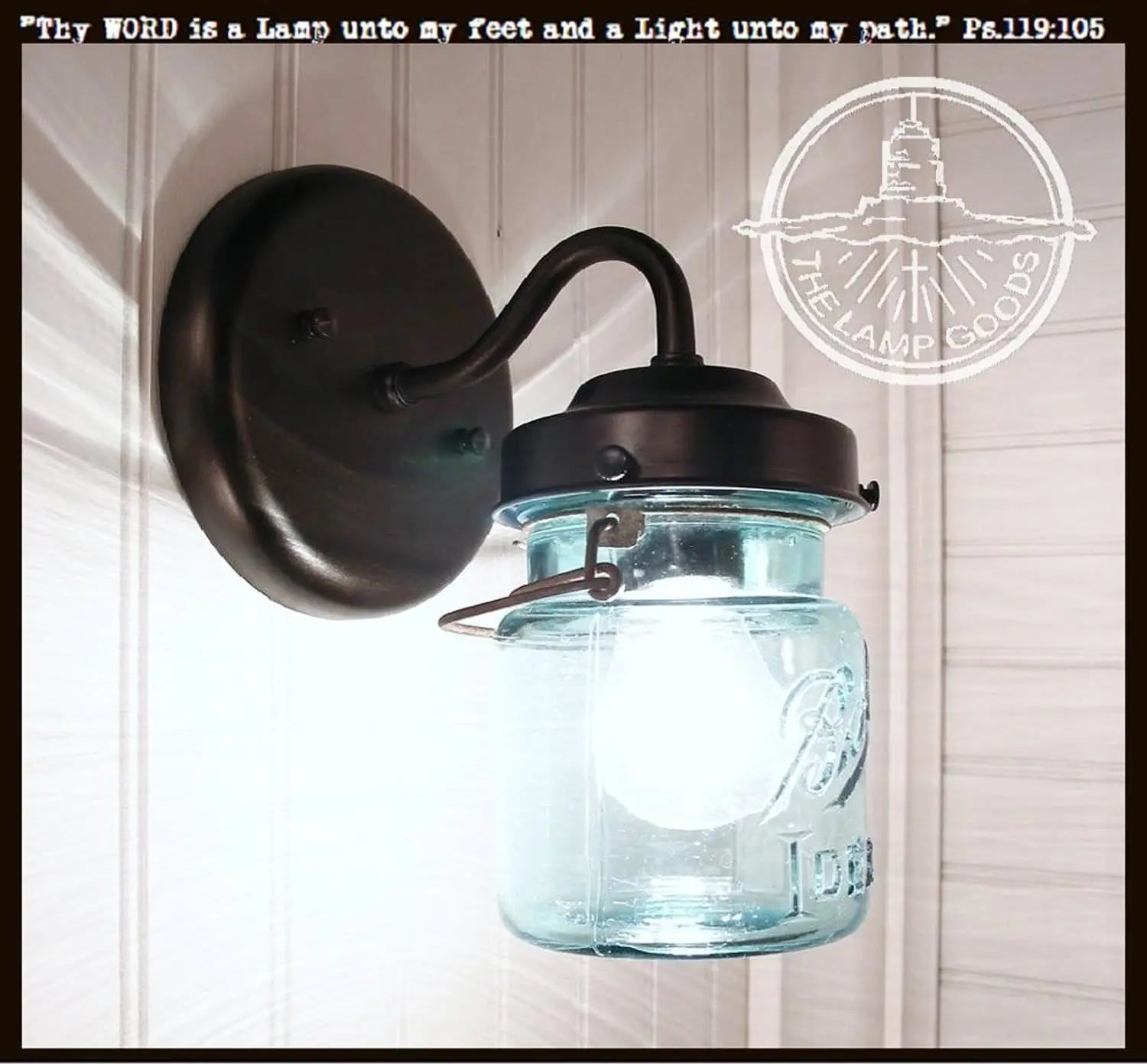 Blue mason jar light fixture sconce with dark bronze metal arm; The Lamp Goods.
