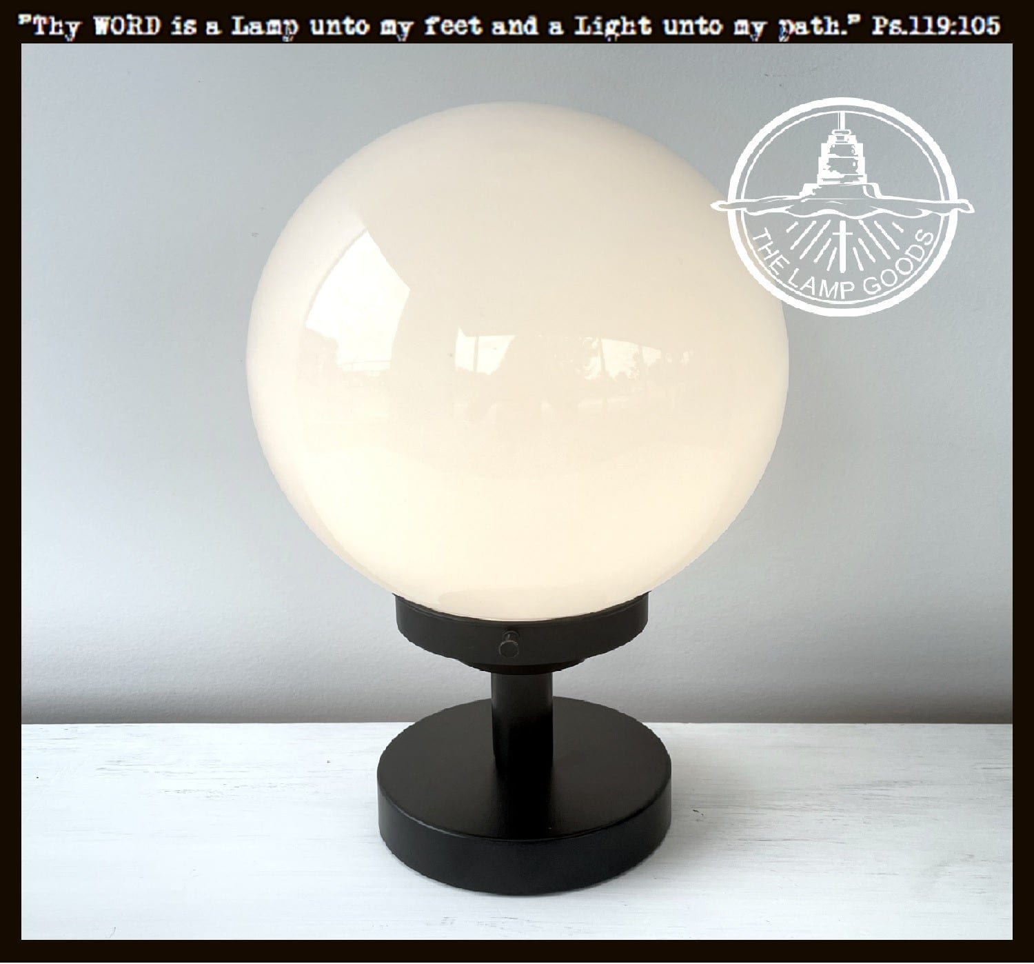 Milk glass globe table lamp with black metal base; The Lamp Goods.
