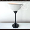 White modern farmhouse table lamp with black base.
